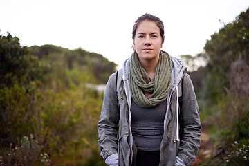 Image showing Woman, hiking and outdoor in bush for portrait on path with fitness, walking or adventure on holiday. Girl, person and trekking in nature, hill or rocks by plants for journey on vacation in Cape Town