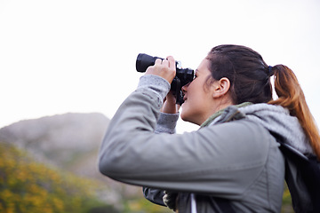 Image showing Woman, binoculars and hiking mountain for nature view on trekking path for explore, adventure or journey. Female person, backpacking and travel workout in wilderness fitness, vacation or environment