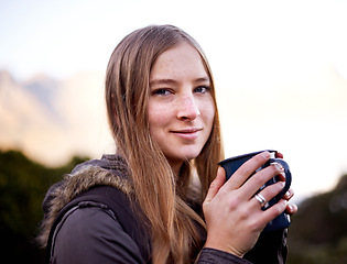 Image showing Hiking, portrait and woman drinking coffee outdoor on vacation, adventure and travel in the morning in Switzerland. Face, tea cup and person trekking in nature or environment in winter on holiday