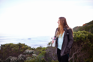 Image showing Woman, hiking and outdoor with bottle, water and space for mockup with fitness, vision or memory on adventure. Girl, person and hydration in bush, mountains and path for journey by ocean in Cape Town