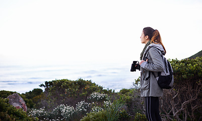 Image showing Woman, mountain and binoculars view or outdoor trekking hike for holiday exercise, explore or journey. Female person, workout and walking on nature path for healthy sport, backpacking or adventure