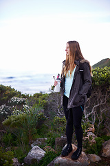 Image showing Woman, hiking and outdoor in nature with bottle for water with fitness, hydration or vision on adventure. Girl, person and trekking in bush, mountains and rocks for journey on vacation in Cape Town