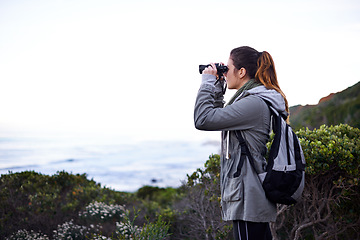 Image showing Woman, mountain and binoculars in nature environment for trekking hike for holiday, explore or journey. Female person, workout and walking on wilderness path for healthy, backpacking or adventure