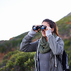 Image showing Woman, hiking and outdoor in nature with binoculars for vision for fitness, location and memory on adventure. Girl, person and trekking in bush, mountains and scenic view on vacation in Cape Town