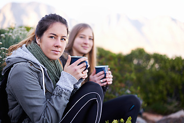 Image showing Hiking, woman and portrait of friends drinking coffee outdoor or relax in environment. Trekking, nature and face of girls with tea cup on adventure, travel and serious people on vacation together