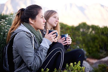 Image showing Hiking, women and friends drinking coffee outdoor, thinking or relax in environment. Trekking, nature and girls with tea cup on adventure, travel and serious on vacation together for journey by bush