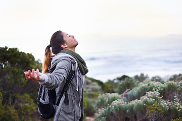 Image showing Woman, hiking and view celebration on mountain for nature adventure for backpacking journey, travel or vacation. Female person, bush and freedom for training trekking or exercise, wellness or fitness