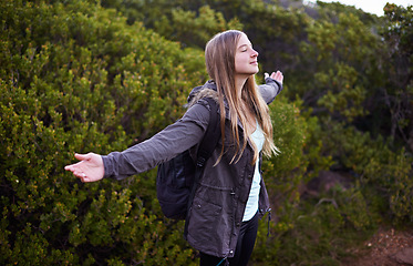 Image showing Woman, hiking and celebration of mountain view for adventure backpacking or journey, travel or freedom. Female person, happy and foliage or training on trekking path or exercise, wellness or fitness