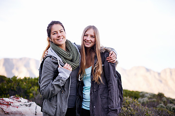 Image showing Friends, smile and portrait for hiking and adventure in nature with mountain for walking outdoor for exercise. Young people, hikers and hugging in landscape with bush and plants for bonding and joy