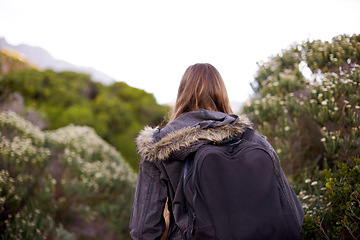 Image showing Outdoor, hiking or walking of girl with backpack for journey in foliage or bush for adventure or vacation. Adult, female person and woman trekking for travel for holiday in winter of Cape Town