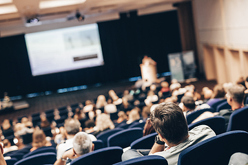 Image showing Speaker giving a talk on scientific conference. Audience at the conference hall. Business and Entrepreneurship concept.