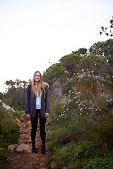 Image showing Woman, hiking and outdoor in nature for portrait on path with fitness, smile or adventure on holiday. Girl, person and trekking in bush, mountains and rocks for journey on vacation in Cape Town