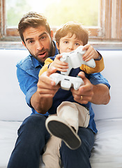 Image showing Father, kid or remote to play, gaming or virtual to relax, esports or technology in living room. Dad, child or controller on sofa to teach, fun or challenge as video game, bonding or together