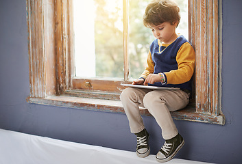 Image showing House, tablet and serious kid on internet, app or game on website for learning by windowsill. Technology, child and boy in home for education, scroll and watch cartoon online on digital electronics