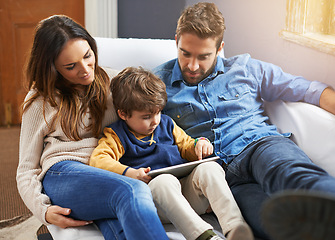 Image showing Family, parents and child with tablet for streaming, relax on couch with cartoon or e learning games at home for bonding. Love, care and trust with digital tech, play online or people watch a movie