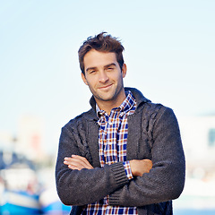 Image showing Smile, crossed arms and portrait of man at harbor on travel for vacation, adventure or holiday. Happy, outdoor and confident person by sea port on weekend trip in Cape Town with positive attitude.