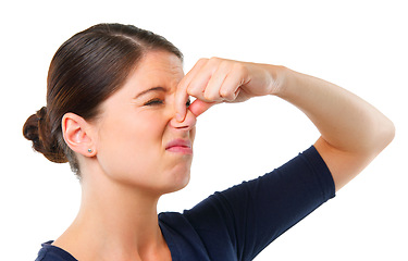 Image showing Smelly, yuck and woman with disgust facial expression for gross, fart and odor on white background and alone. Young person or model and isolated with finger on nose for stink or scent on mockup