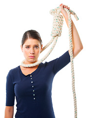 Image showing Girl, portrait and rope on neck in studio for struggle or trapped, crisis and helplessness with risk. Female person, noose and scared with fear for rescue, distress and isolated on white background.