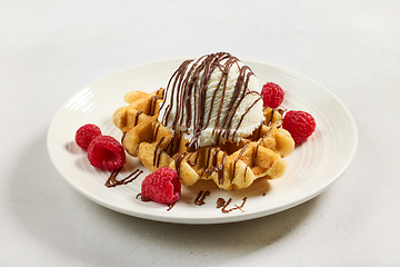 Image showing belgian waffle decorated with melted chocolate sauce and ice cre