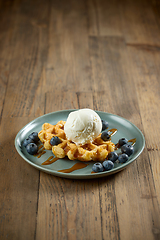 Image showing plate of belgian waffle with caramel sauce and blueberries