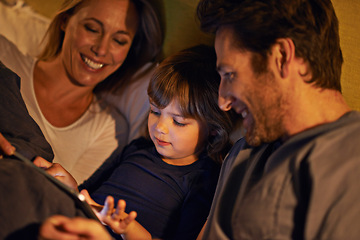 Image showing Night, parents or kid with tablet for streaming, playing games or watching videos on movie website in home. Social media, child or happy mom with dad or technology to download on ebook online in bed