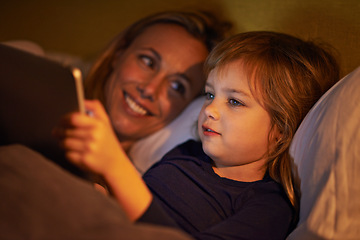 Image showing Night, mother or kid with tablet for streaming, playing games or watching videos on movie website in home. Social media, child or happy mom with smile or technology to download on ebook online in bed