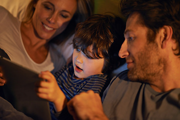 Image showing Bed, parents or kid with tablet for streaming, playing games or watching videos on movie website in home. Social media, child or happy mom with dad or technology to download on ebook online at night