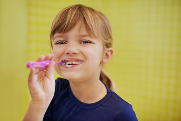 Image showing Girl, portrait or child in studio brushing teeth with smile for development isolated on yellow background. Morning, learn or kid cleaning mouth with toothbrush for dental or oral health for wellness