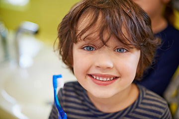 Image showing Boy, portrait or child in home brushing teeth with smile for development morning routine in bathroom. Face, learning or happy kid cleaning mouth with toothbrush for dental or oral health for wellness