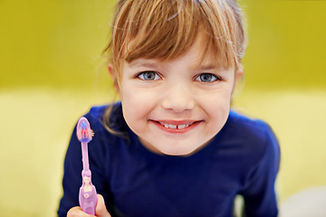 Image showing Girl, portrait or kid in home brushing teeth with smile or development or morning routine in bathroom. Face, learning or happy child cleaning mouth with toothbrush for dental, wellness or oral health