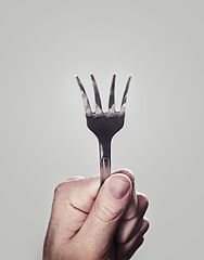 Image showing Bending, fork and hand with closeup, person and utensils with kitchen tool on a white studio background. Mockup space, promotion and model with superpower and magic with design, artistic and creative