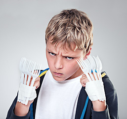 Image showing Portrait, angry and boy with fist, fight and expression with frustrated on grey studio background. Face, model and kid with forks for claws and reaction with costume and aggressive with rage or child