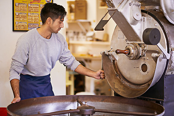 Image showing Coffee, production and man with machine for roasting with blending, small business and quality control. Entrepreneur, barista or roaster with beans at cafe, sustainable startup and espresso process