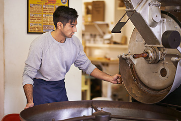 Image showing Coffee, process and man with machine for roasting with blending, small business and quality control. Entrepreneur, barista or roaster with beans at cafe, sustainable startup and espresso production