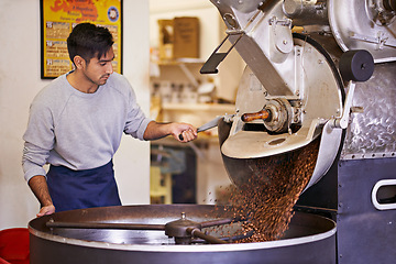 Image showing Coffee beans, process and man with machine for roasting with blending, production and quality control. Entrepreneur, barista or espresso roaster at cafe, sustainable startup shop and small business