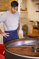 Image showing Coffee, small business and man with machine for roasting with blending, production and quality control. Entrepreneur, barista or roaster with beans at cafe, sustainable startup and espresso process