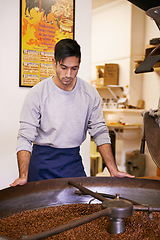 Image showing Coffee, quality and man with machine for roasting with blending, production and small business. Entrepreneur, barista or roaster with beans at cafe, sustainable startup and espresso process at shop