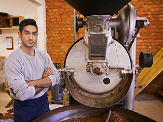Image showing Coffee, small business and portrait of man with roasting machine for blending, production and quality control. Entrepreneur, barista and arms crossed with beans, sustainable cafe and espresso process
