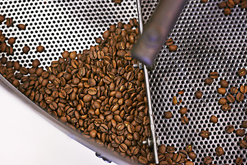 Image showing Coffee beans, machine and industry in factory for roast, grinding or product for flavor, export or quality assurance. Plant, metal container and manufacturing for organic caffeine with sustainability