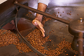 Image showing Coffee beans, machine and hands in industry for roast, grinding or production for flavor, export or quality assurance. Person, factory and manufacturing for caffeine with organic stock for ecology