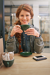 Image showing Woman, cup and happy in coffee shop for portrait at breakfast to start morning at table. Girl, person and smile in cafeteria with flavor, aroma and relax in restaurant for catering service in Dublin