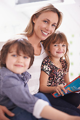 Image showing Portrait, mother and children on sofa reading book with bonding, teaching and learning together in home. Mom, son and daughter relax on couch with storytelling, smile and happy family in living room