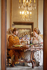 Image showing Royal, man and woman with wine for luxury and toast together for wedding and coronation. King and queen with smile for food with alcohol to drink in palace, happiness and joy for wealth in marriage