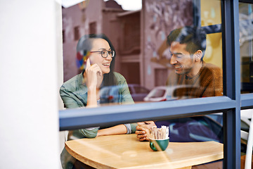 Image showing Happy couple, relax and enjoying cafe with date for conversation, bonding or romance at indoor restaurant. Man and woman with smile by window at coffee shop for social, talking or chatting at table