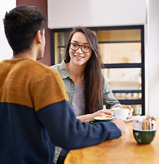 Image showing Coffee shop, talking and couple on date with drink in conversation, discussion and chat for bonding. Love, happy and man and woman with caffeine, cappuccino or beverage in restaurant, cafe and store