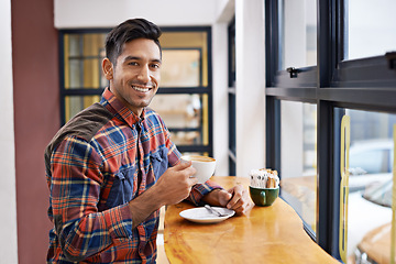 Image showing Happy man, portrait and relax with coffee by window for morning, breakfast or start of the day. Male person with smile, drink or beverage for caffeine, mug or cup of tea at indoor restaurant or cafe