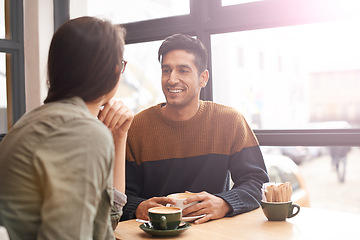 Image showing Coffee shop, happy and couple with drink on date in conversation, talking and chatting for bonding. Love, relax and man and woman with caffeine, cappuccino and beverage in restaurant, cafe and store