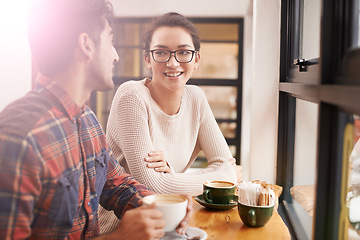 Image showing Happy people, friends and relax with coffee at cafe for chatting, talking or social bonding. Young man and woman with smile for conversation, beverage or morning drink at indoor restaurant together