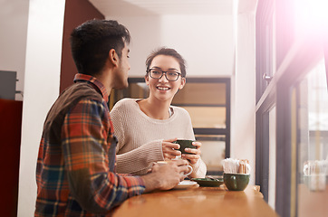 Image showing Couple, date and coffee shop with smile and talking together with hot drink in a cafe. Woman, conversation and happy from discussion and chat in a restaurant with tea or cappuccino at a table