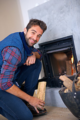 Image showing Fireplace, happy and portrait of man in home with fire for heat, warmth and light in winter. Flame, hearth and person with firewood, log and wood for comfort, cozy and relaxing house in living room